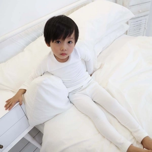 Detail of white cotton thermal sleepwear set for kids showing soft neck and fabric texture