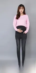 Detail of pregnancy jeans with high elastic belly support band and pink long sleeve tee