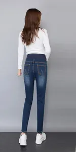 Close-up of maternity skinny jeans featuring a high-waist elastic belly support band