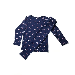 Detail of dark blue kids' cotton pajama set featuring white and pink butterfly patterns