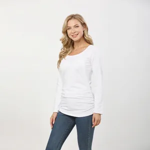 Detail view of white long sleeve nursing top with side ruched waist and soft cotton texture