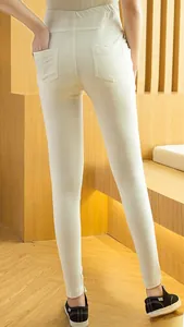 Macro detail of high-waist white maternity leggings featuring dual back pockets and hemmed cuff
