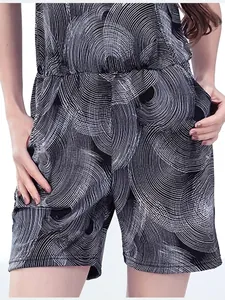 Summer V-neck maternity romper with stylish black and white swirl print and pockets