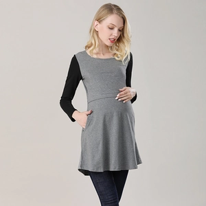 Detail of grey maternity shirt featuring black sleeves and hidden nursing side pockets