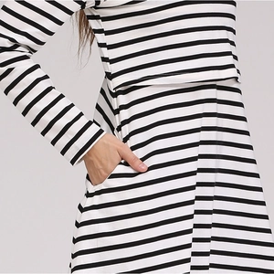 Detail of striped maternity top featuring overlapping nursing layer and side pockets