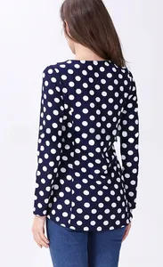 Back view of a navy blue polka dot nursing top with round neck and long sleeves detail