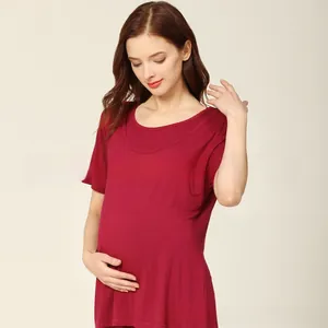 Detailed close-up of soft modal fabric and comfortable fit of the wine red maternity top