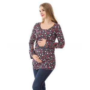 Detail of floral maternity top with long sleeves and round neck on white background