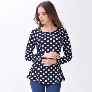 Close-up of long sleeve polka dot nursing top with round neck and peplum hemline detail