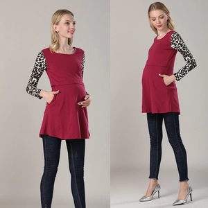 Detail of burgundy maternity top with leopard print sleeves and functional side pockets