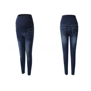 Detail view of high-waist maternity jeans with elastic belly support in dark blue denim