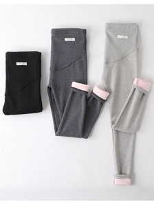 Detail of fleece-lined maternity leggings in black and grey with soft pink interior lining