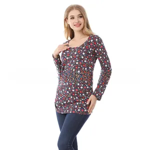 Close-up of long sleeve floral top with red and white print on a dark base
