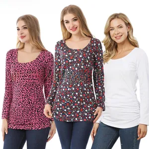 Close-up of three long-sleeve maternity tops in leopard print, floral, and white colors