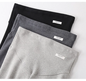 Detail of high-waist maternity leggings featuring elastic wide waistband in three colors