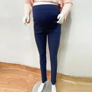 Detailed view of high-waisted maternity leggings with supportive belly band in navy blue