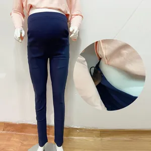 Detail of adjustable waist buckle on navy blue high-waist maternity leggings for women