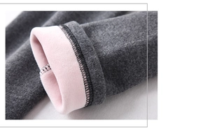 Detail of warm maternity leggings with thick pink fleece lining and grey knit fabric