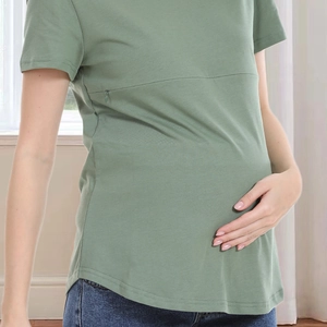 Detail of sage green maternity nursing T-shirt with hidden zipper and soft cotton texture