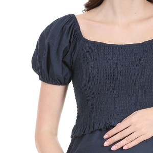 Detail of smocked elastic chest and square neckline on dark blue maternity puff sleeve dress