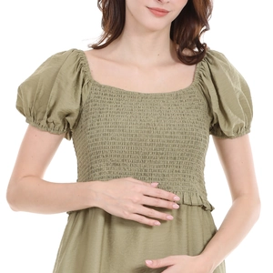 Detail of olive green maternity dress with square neck and puffed sleeves in cotton linen