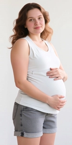 Detail of white maternity nursing tank top with side zipper and denim shorts with cuffed hems