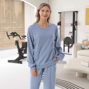 Women's light blue waffle knit loungewear set featuring long sleeve top and matching pants