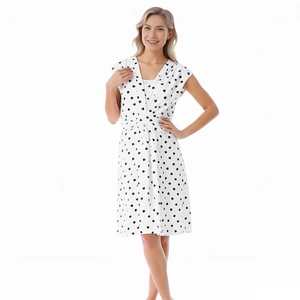 Detail of V-neckline and crossed waist design on a white heart print maternity dress
