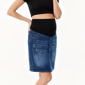 Détail d'une jupe en jean de maternité avec bandeau de soutien du ventre élastique noir