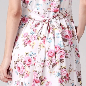 Detail of floral maternity dress back bow tie and pink rose print on white cotton