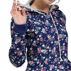 Detail of floral print hoodie showing the drawstring hood and ribbed cuffs on fabric
