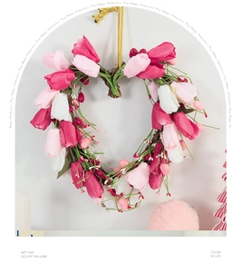 Detail of heart-shaped tulip wreath with pink silk flowers and golden hanging rope