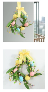 Detail view of Easter wreath with colorful foam eggs, berries, and a plaid ribbon bow