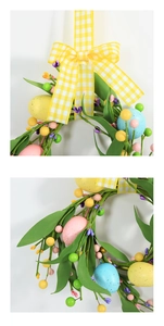 Detail of Easter wreath featuring colorful eggs, faux berries and yellow plaid ribbon bow