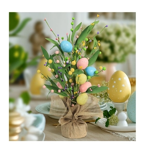 Detailed view of Easter egg centerpiece with faux berries and burlap wrapped base