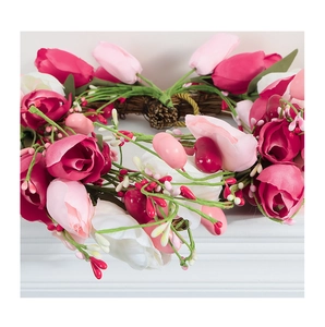 Detail of handmade pink tulip heart wreath with berries on natural vine base
