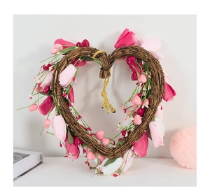 Macro view of heart-shaped rattan wreath with pink petals and berries for home decor