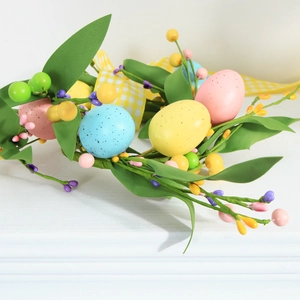 Easter egg floral wreath with berries and checkered bow on white tabletop