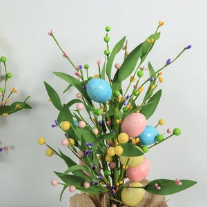 Easter egg berry cuttings with colorful eggs and green leaves in burlap wrapping