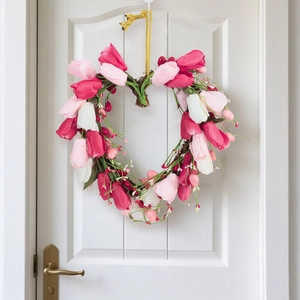 Heart-shaped tulip wreath with pink and white flowers on a natural vine base