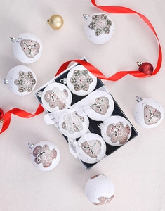 Detail of Christmas balls with gingerbread man and snowflake patterns in gift box