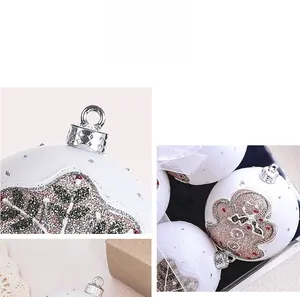 Close-up of white Christmas balls with glitter gingerbread man and silver hanging caps