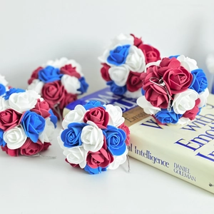 Macro view of red white and blue foam rose ball ornament with silver hanging string