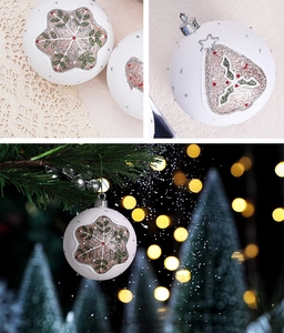Detailed view of matte white Christmas balls with glittery snowflakes and holly leaf patterns