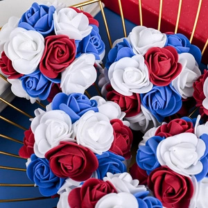 Patriotic red white and blue foam rose decorative balls in a gold metal wire basket