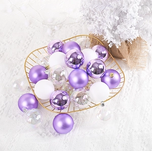 Detail of 6cm Christmas ornaments in purple and white inside a gold wire basket