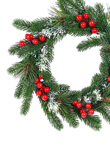 Close-up of frosted pine needles and vibrant red berries on a Christmas wreath