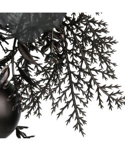 Macro shot of black artificial pine needles and decorative spheres for Halloween decor