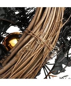 Macro shot of Halloween wreath with natural wood twigs and shiny black and gold ornaments