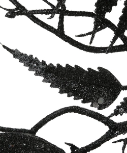 Macro shot of black glittery artificial leaves with shimmering texture for Halloween decor